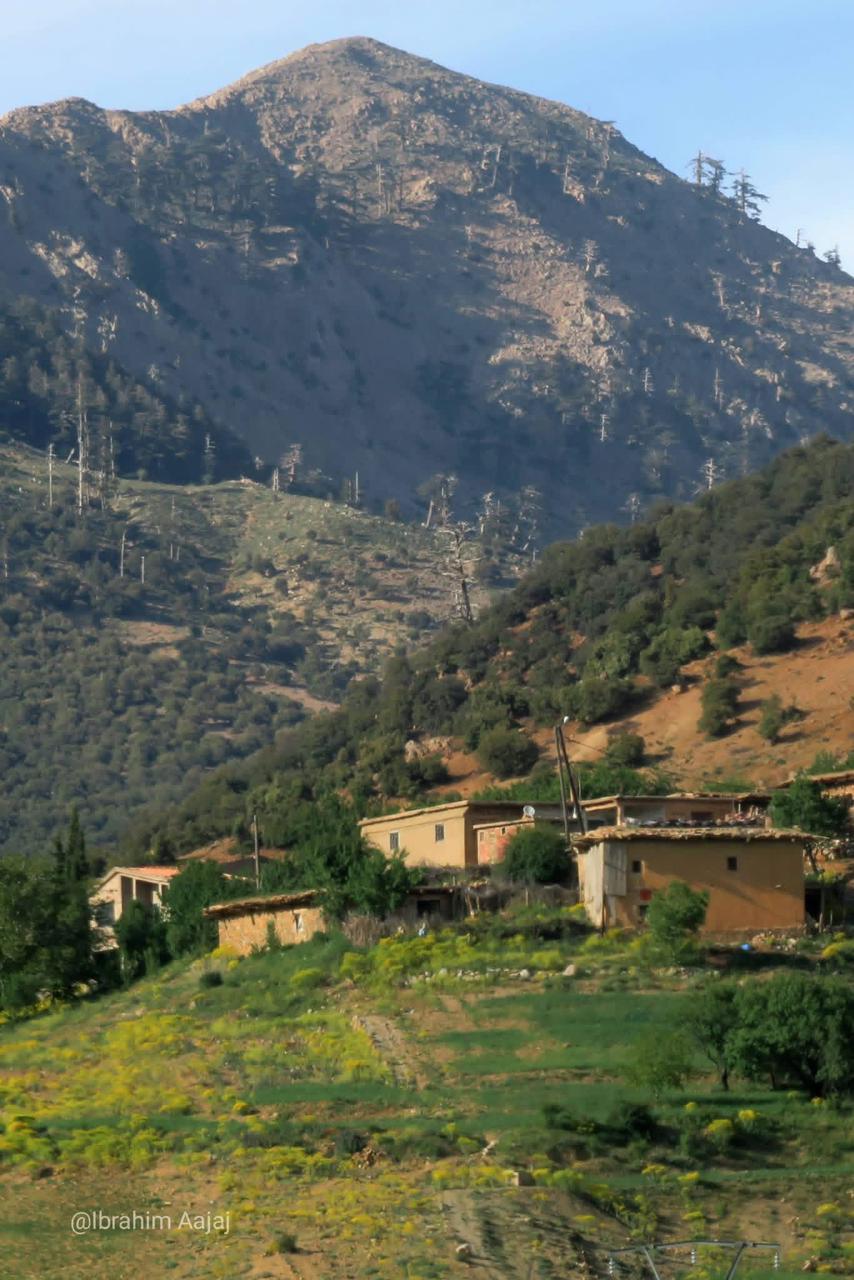 An Atlas mountain village nestled below a rocky peak.